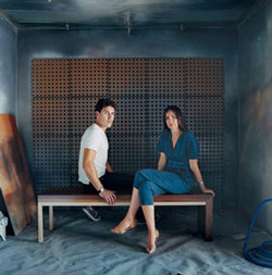 Charlie Ferrer and Ana Meier on a bench from their debut collection at their Los Angeles workshop.