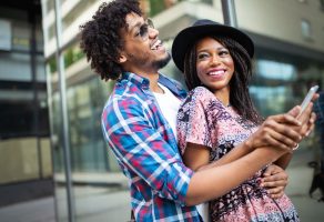 happy young black couple hugging and laughing